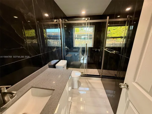 a hallway with a couch and wooden floor