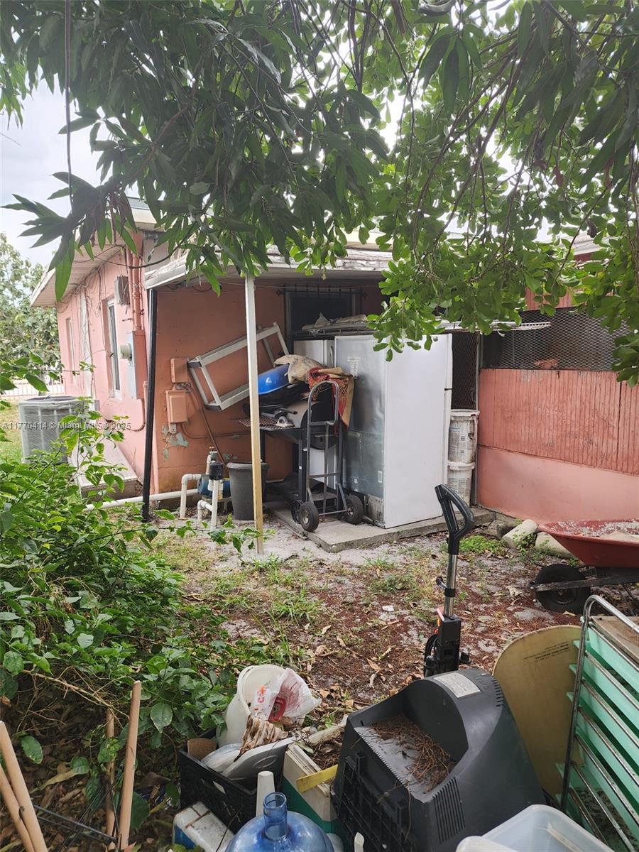 831 Northwest 140th Street Miami, FL 33168 - Photo 15 of 19 a backyard of a house with yard barbeque oven and outdoor seating