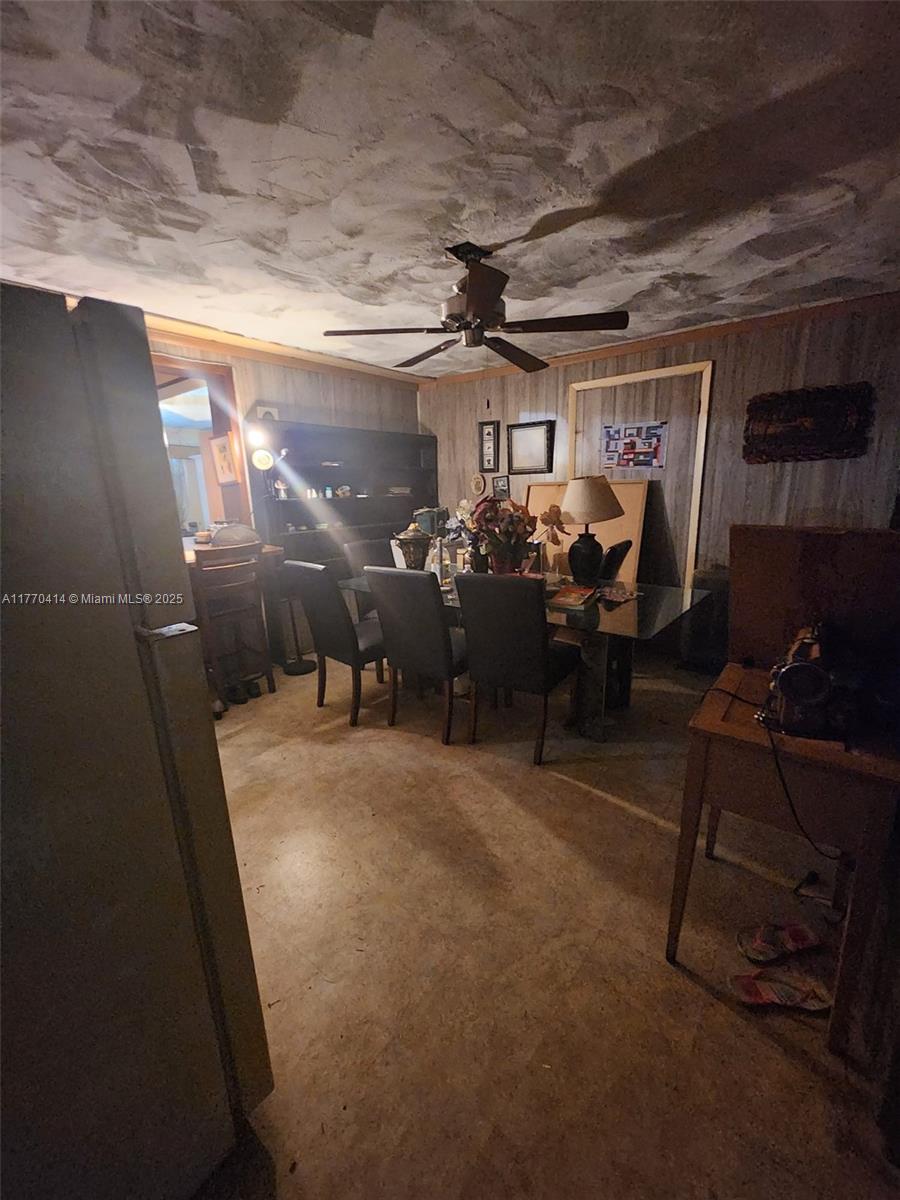 831 Northwest 140th Street Miami, FL 33168 - Photo 9 of 19 a living room with lots of furniture and chairs