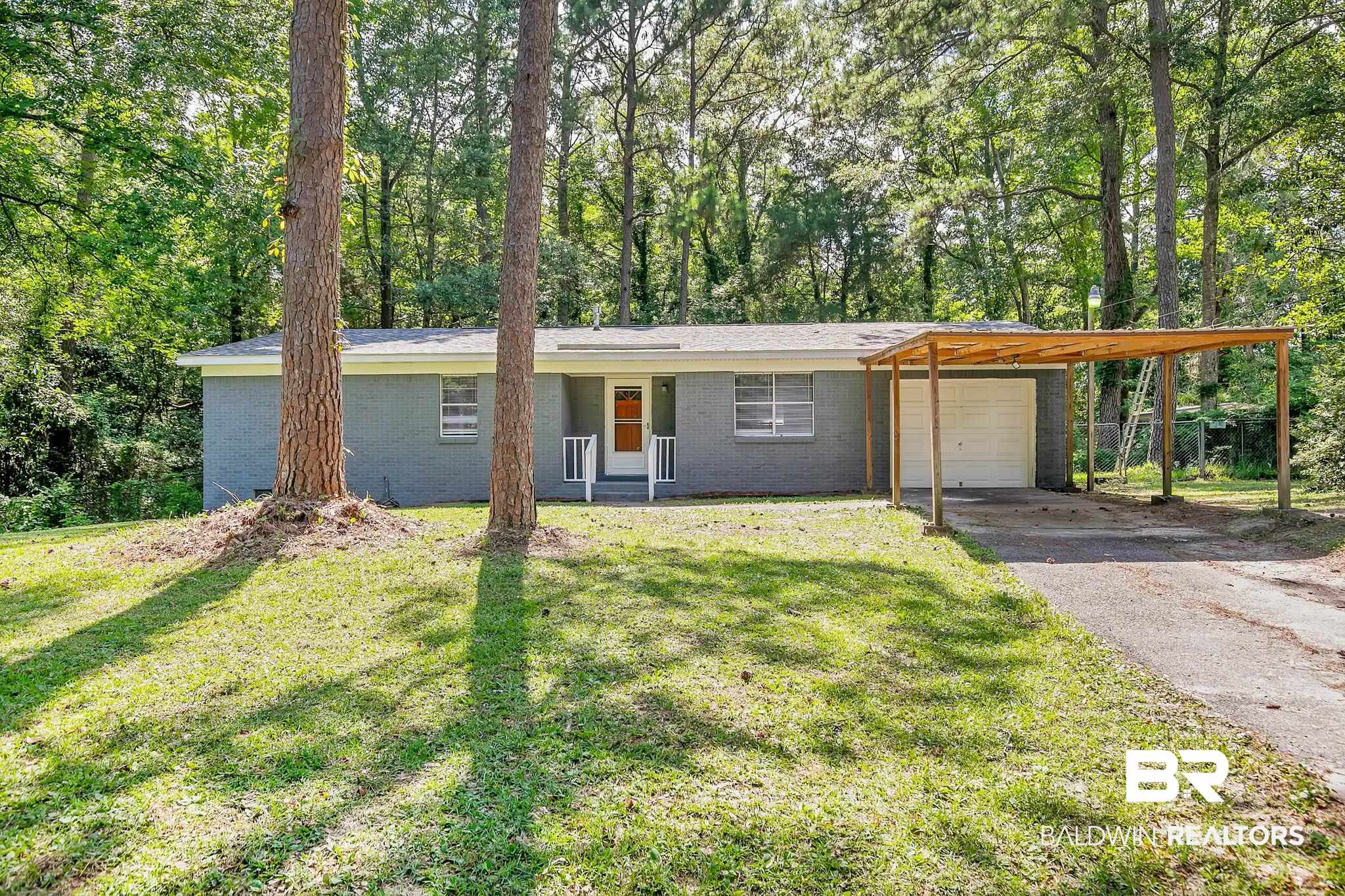3304 Armond Drive Mobile, AL 36605 - Photo 1 of 62 Ranch-style house featuring a front yard, brick siding, and asphalt driveway