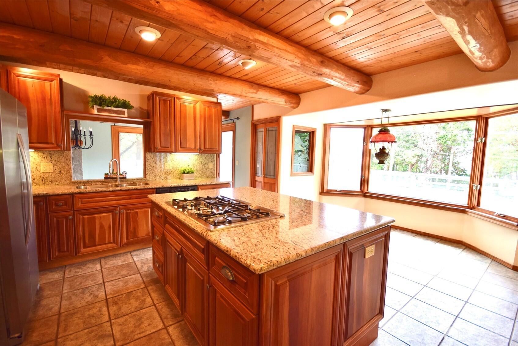 2422 West Sequim Bay Road Sequim, WA 98382 - Photo 15 of 36 a kitchen with stainless steel appliances granite countertop a stove a sink and a microwave