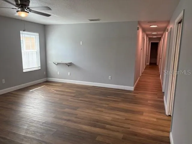 wooden floor in an empty room with a window