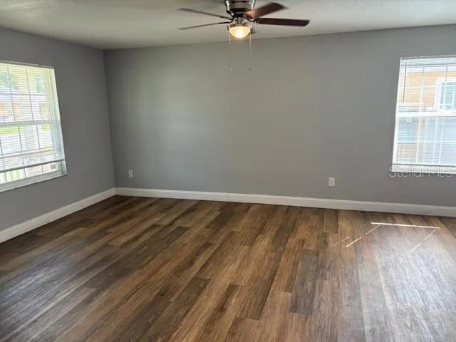 a view of a room with wooden floor and window