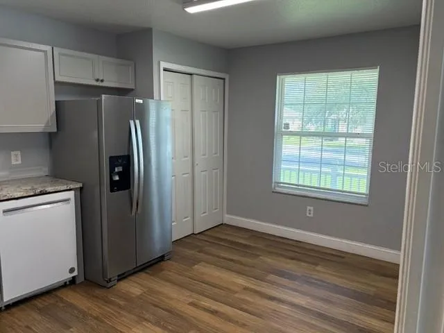 a kitchen with stainless steel appliances a refrigerator and a stove top oven
