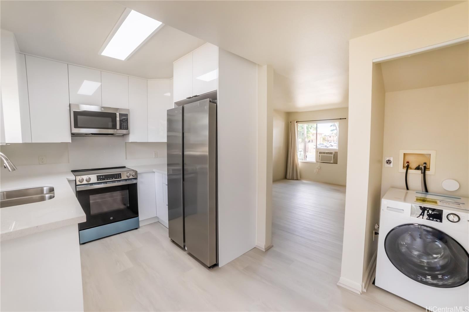 91-1147 Kamaaha Loop, Unit 6F Kapolei, HI 96707 - Photo 11 of 25 a kitchen with a refrigerator and a stove top oven