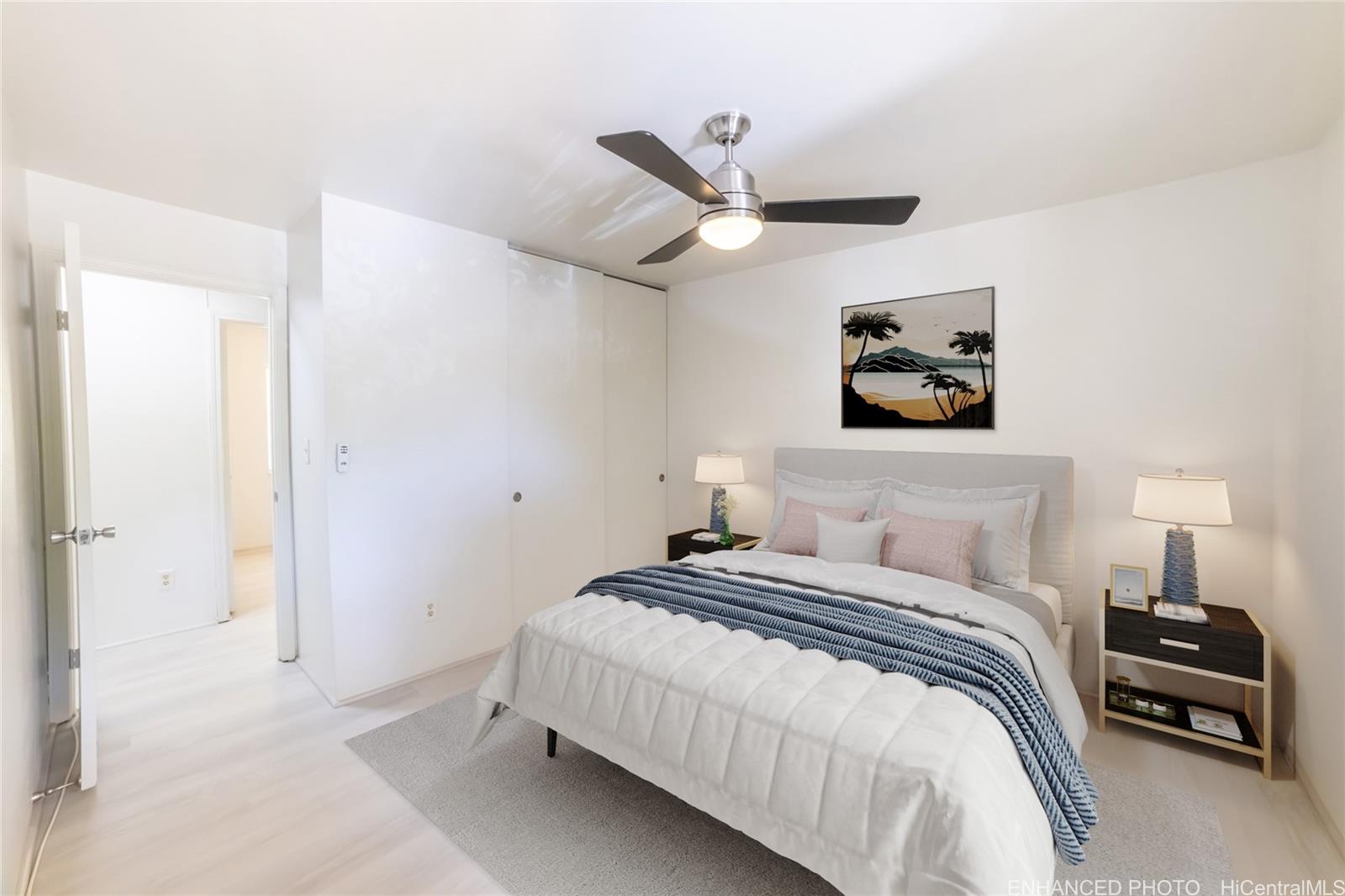 91-1147 Kamaaha Loop, Unit 6F Kapolei, HI 96707 - Photo 17 of 25 a bedroom with a bed and a chandelier