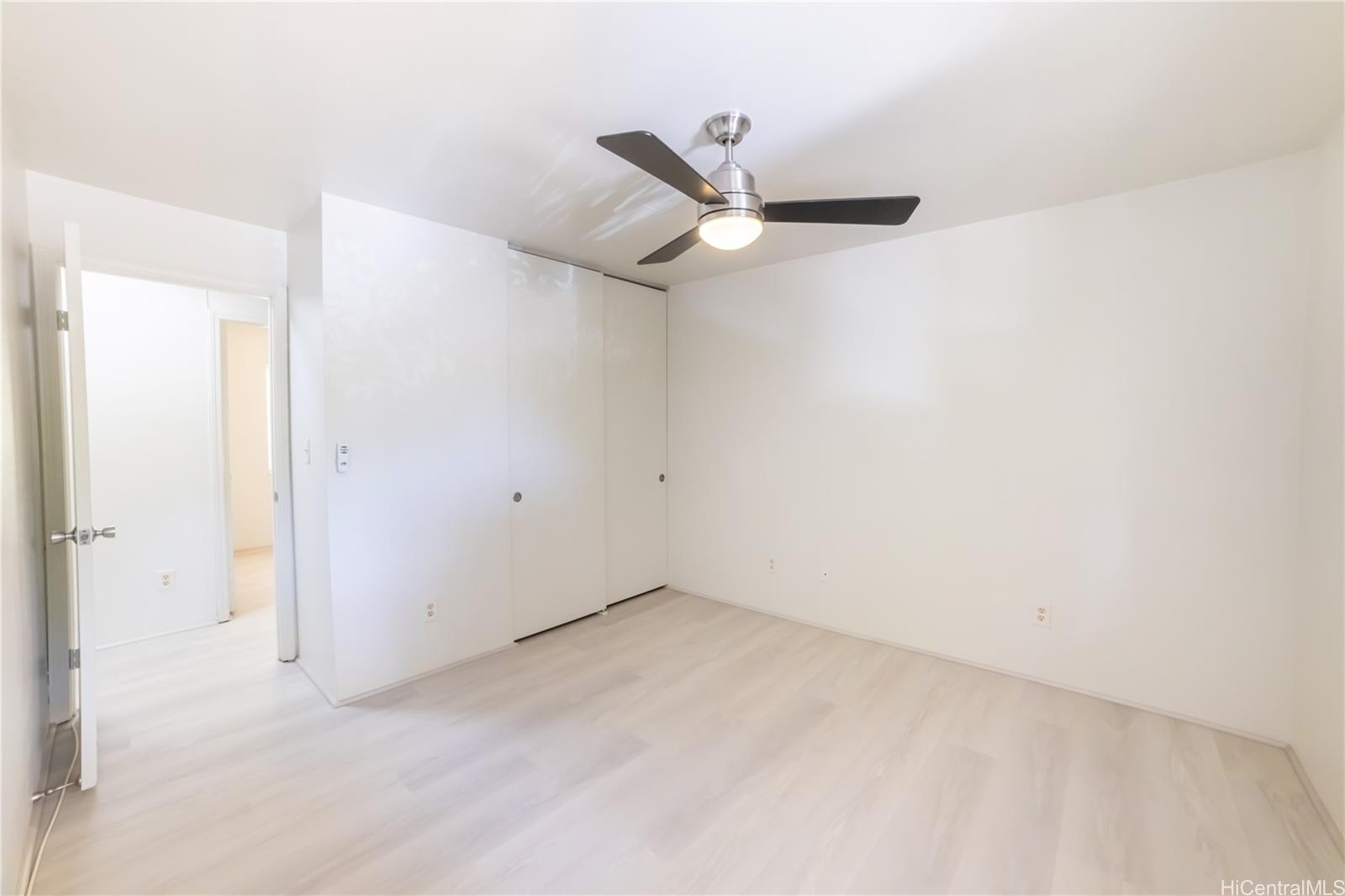 91-1147 Kamaaha Loop, Unit 6F Kapolei, HI 96707 - Photo 18 of 25 an empty room with a ceiling fan and carpet