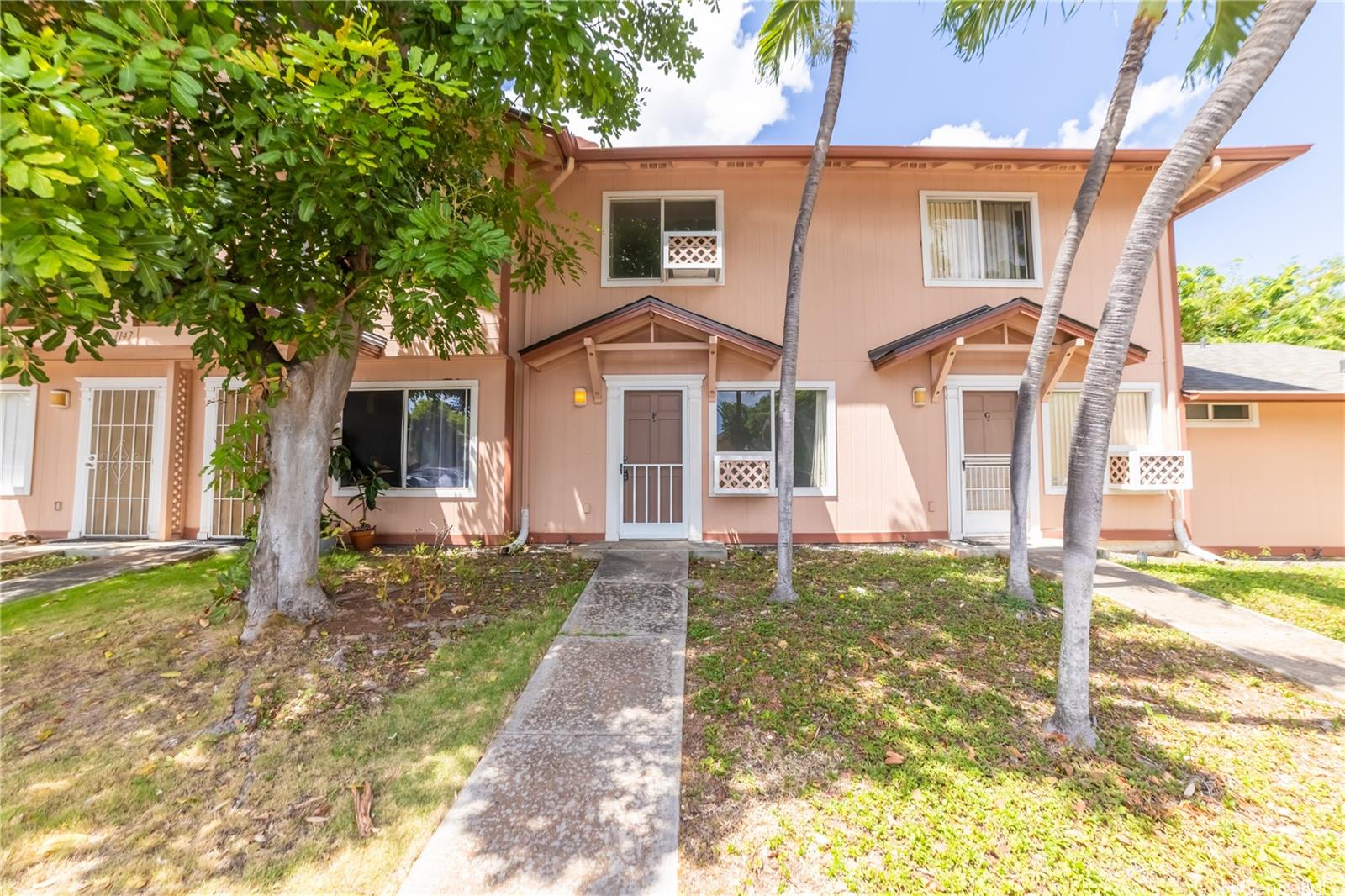 91-1147 Kamaaha Loop, Unit 6F Kapolei, HI 96707 - Photo 23 of 25 a front view of a house with a yard