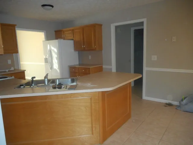 a kitchen with stainless steel appliances a sink stove and refrigerator
