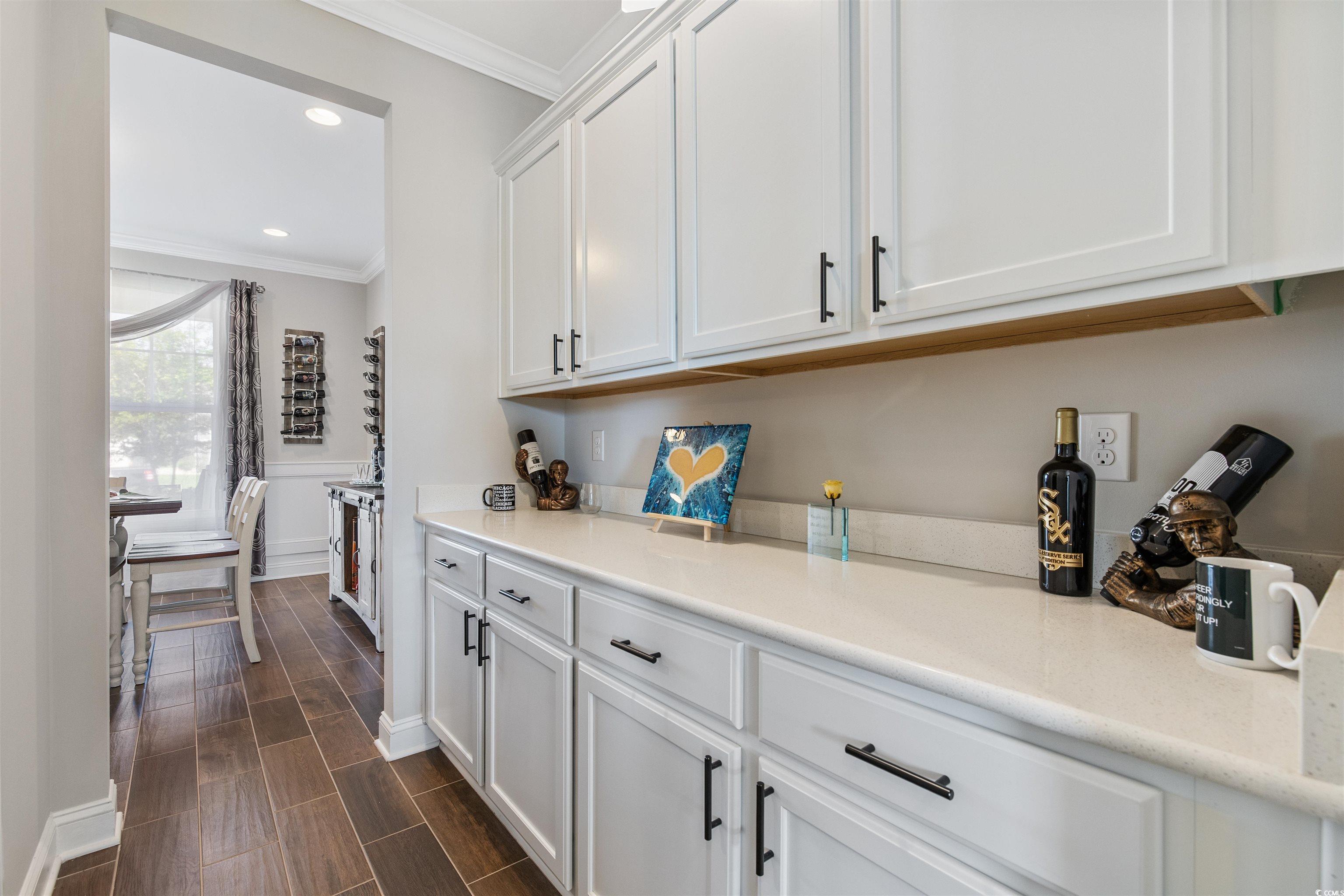 5286 Stockyard Loop Myrtle Beach, SC 29588 - Photo 15 of 40 Kitchen with white cabinetry, ornamental molding, wood finish floors, recessed lighting, and light stone countertops