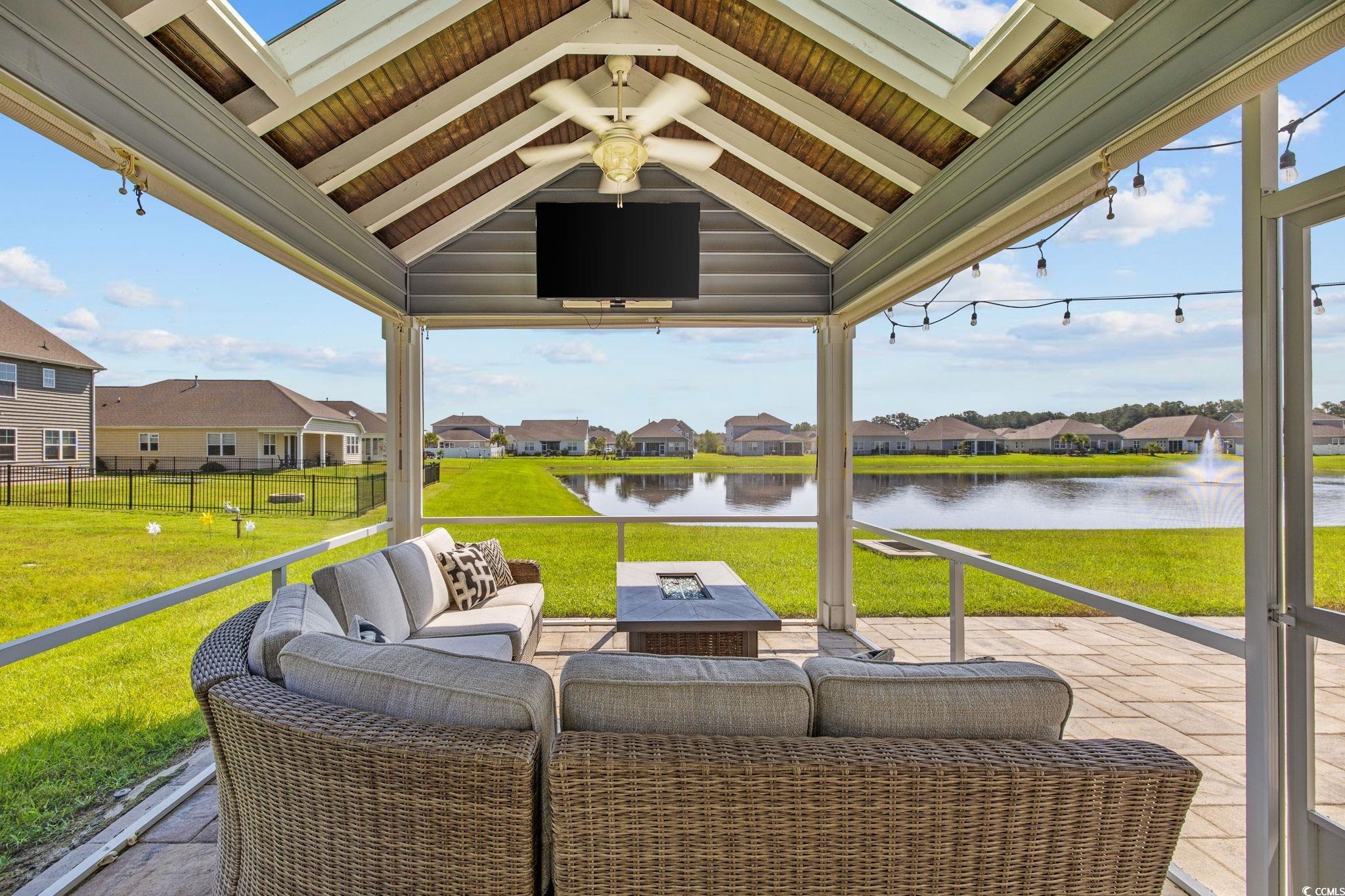 View of patio featuring an outdoor living space with a fire pit and ceiling fan