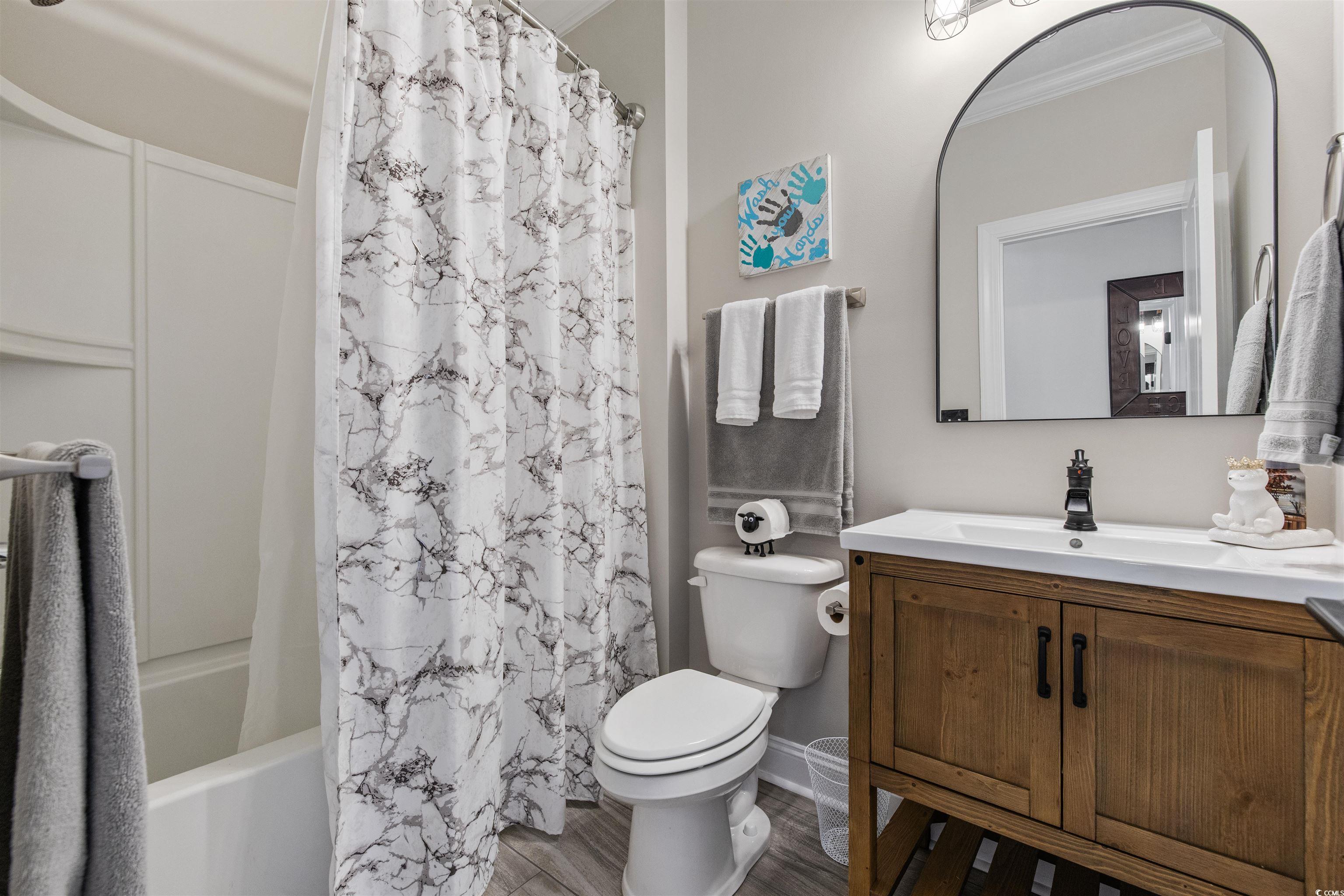5286 Stockyard Loop Myrtle Beach, SC 29588 - Photo 24 of 40 Full bath featuring vanity, shower / tub combo, wood finished floors, and crown molding