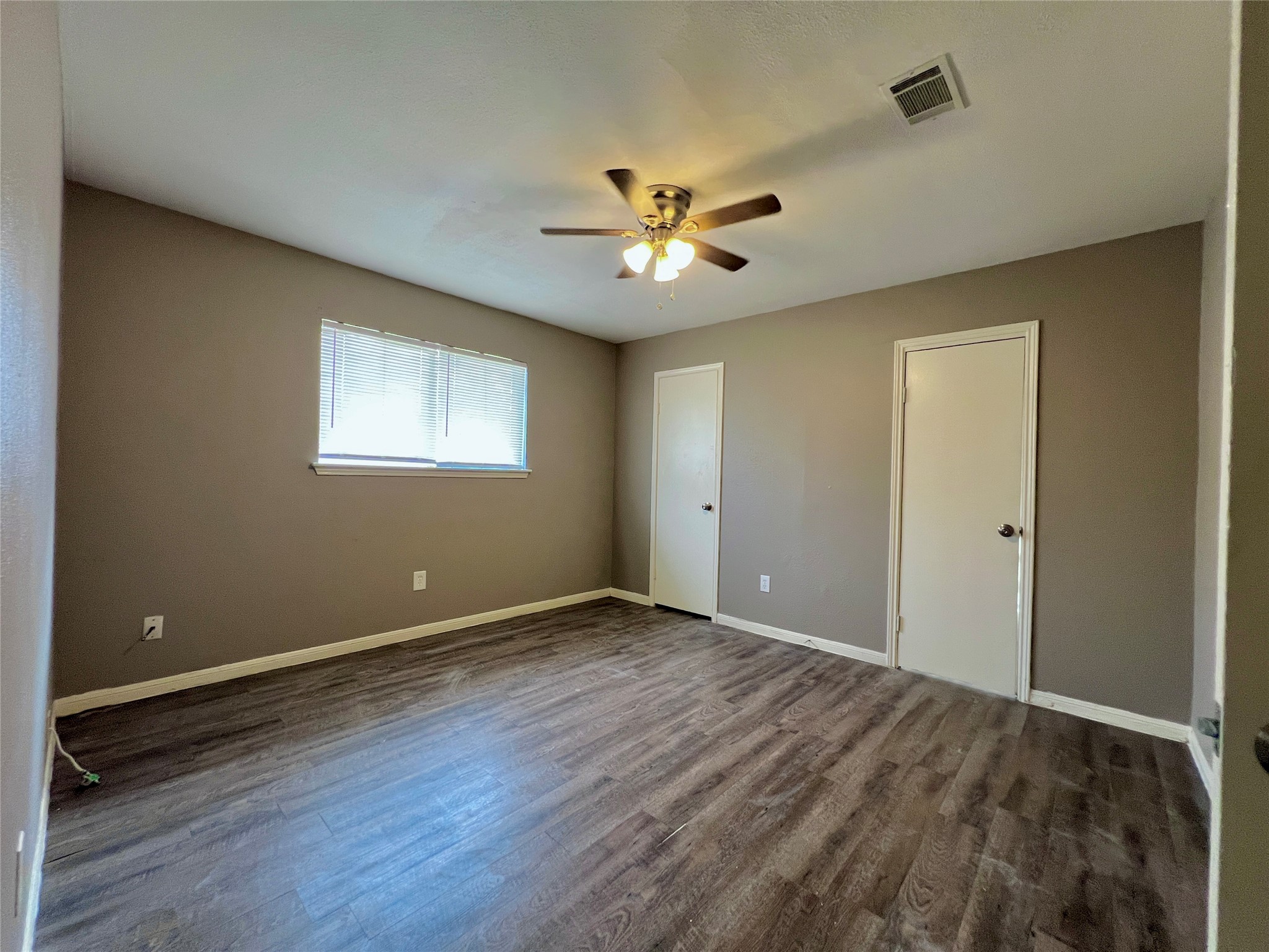 12819 Claygate Drive Houston, TX 77047 - Photo 7 of 12 wooden floor in an empty room with a window