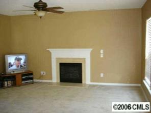 5603 Falls Ridge Lane Charlotte, NC 28269 - Photo 4 of 5 a view of an empty room with a fireplace