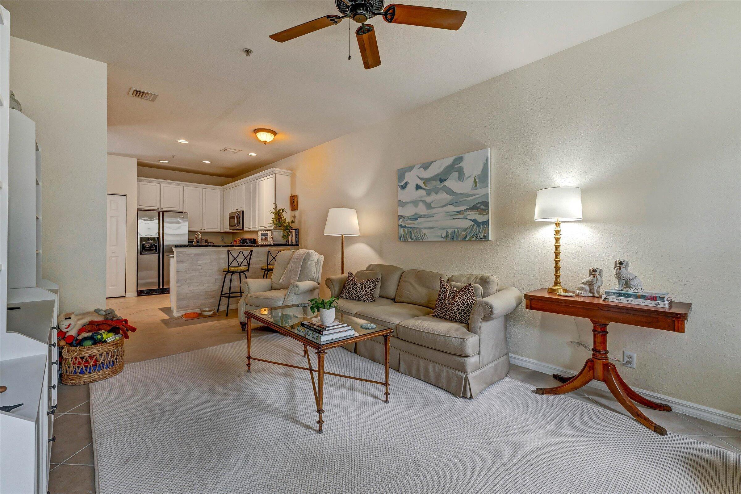 115 Pond Apple Lane, Unit 105 Jupiter, FL 33458 - Photo 16 of 38 a living room with furniture and a potted plant