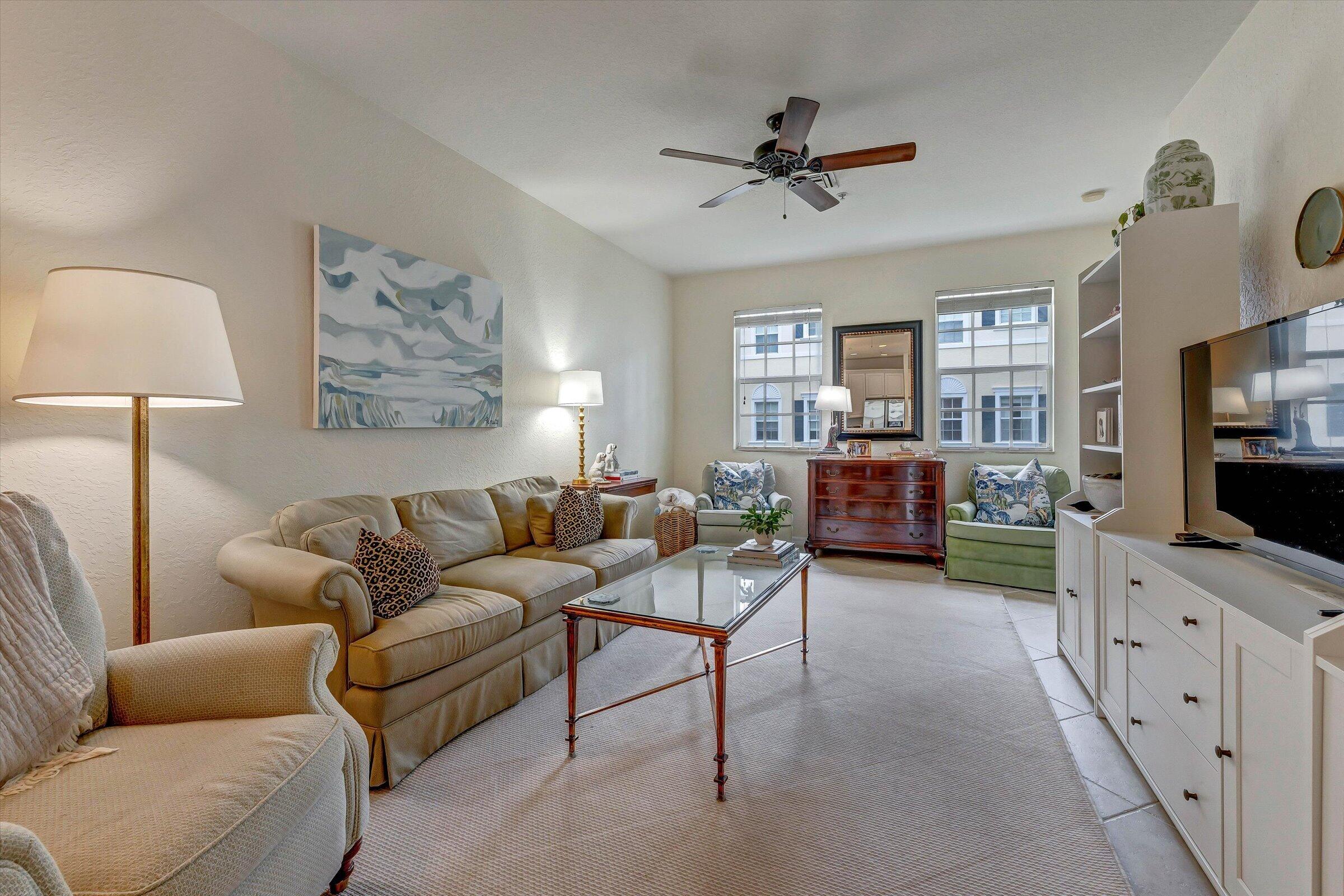 115 Pond Apple Lane, Unit 105 Jupiter, FL 33458 - Photo 17 of 38 a living room with furniture and a flat screen tv