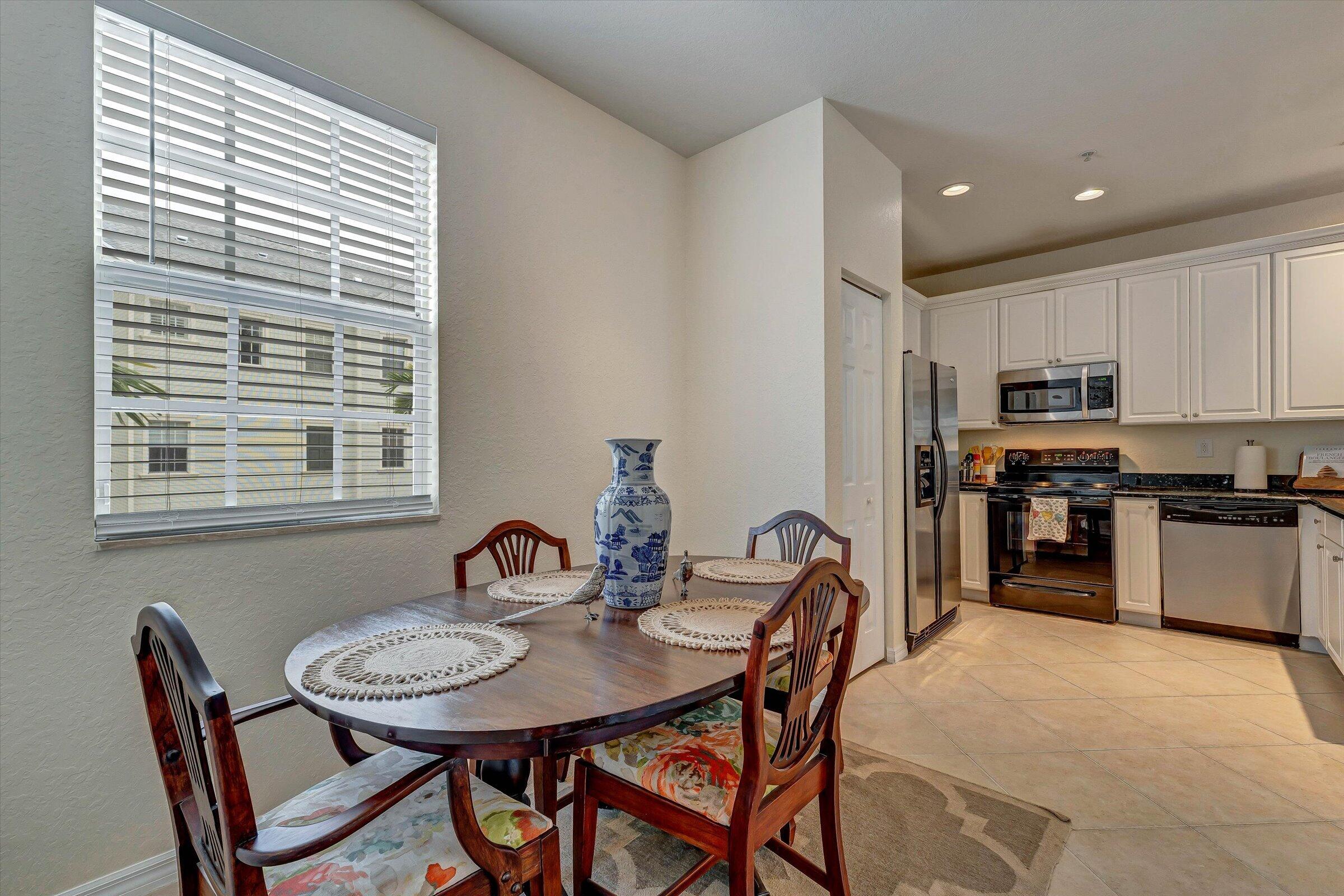 115 Pond Apple Lane, Unit 105 Jupiter, FL 33458 - Photo 19 of 38 a view of a dining room with furniture and window