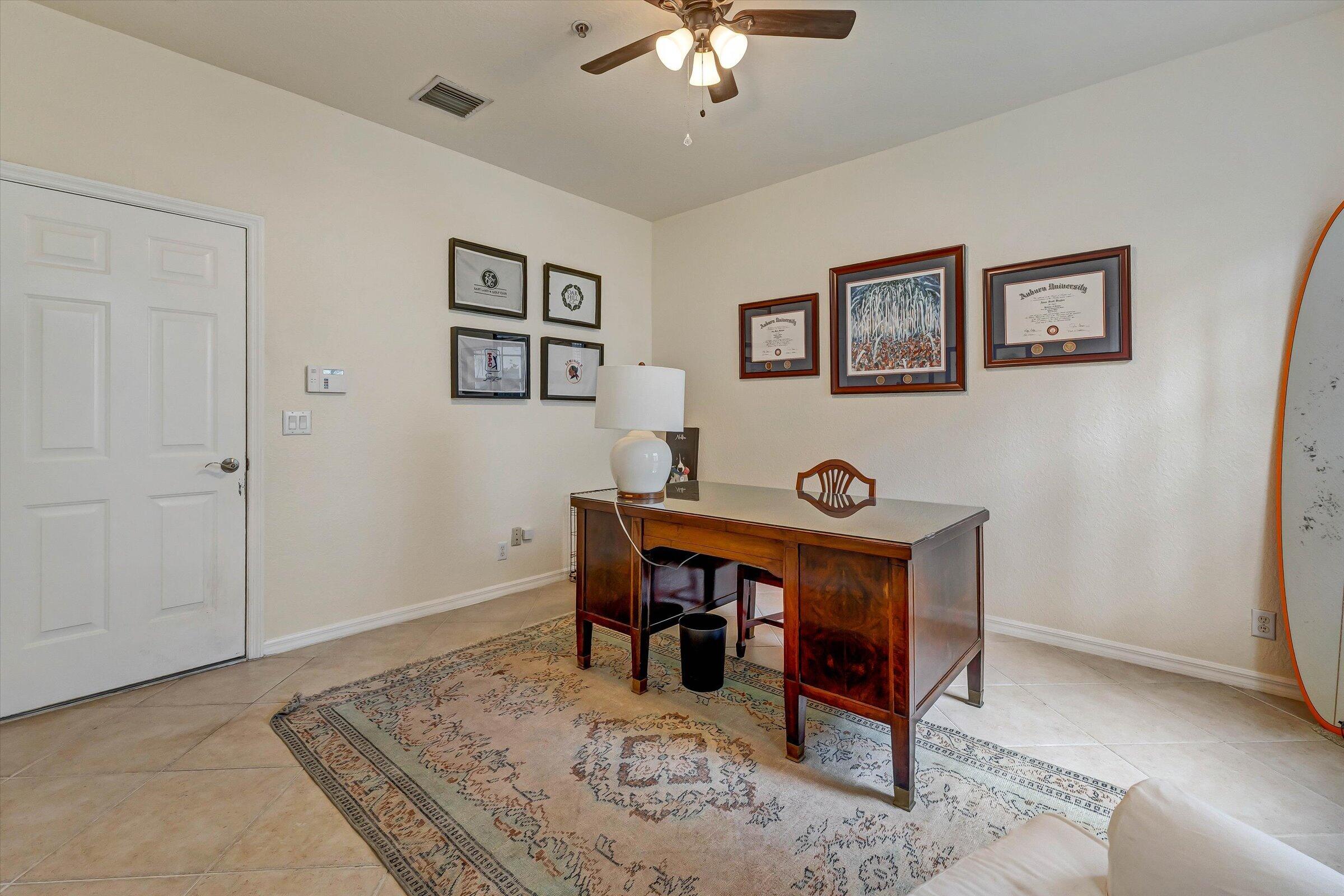 115 Pond Apple Lane, Unit 105 Jupiter, FL 33458 - Photo 28 of 38 a living room with furniture and paintings on the wall