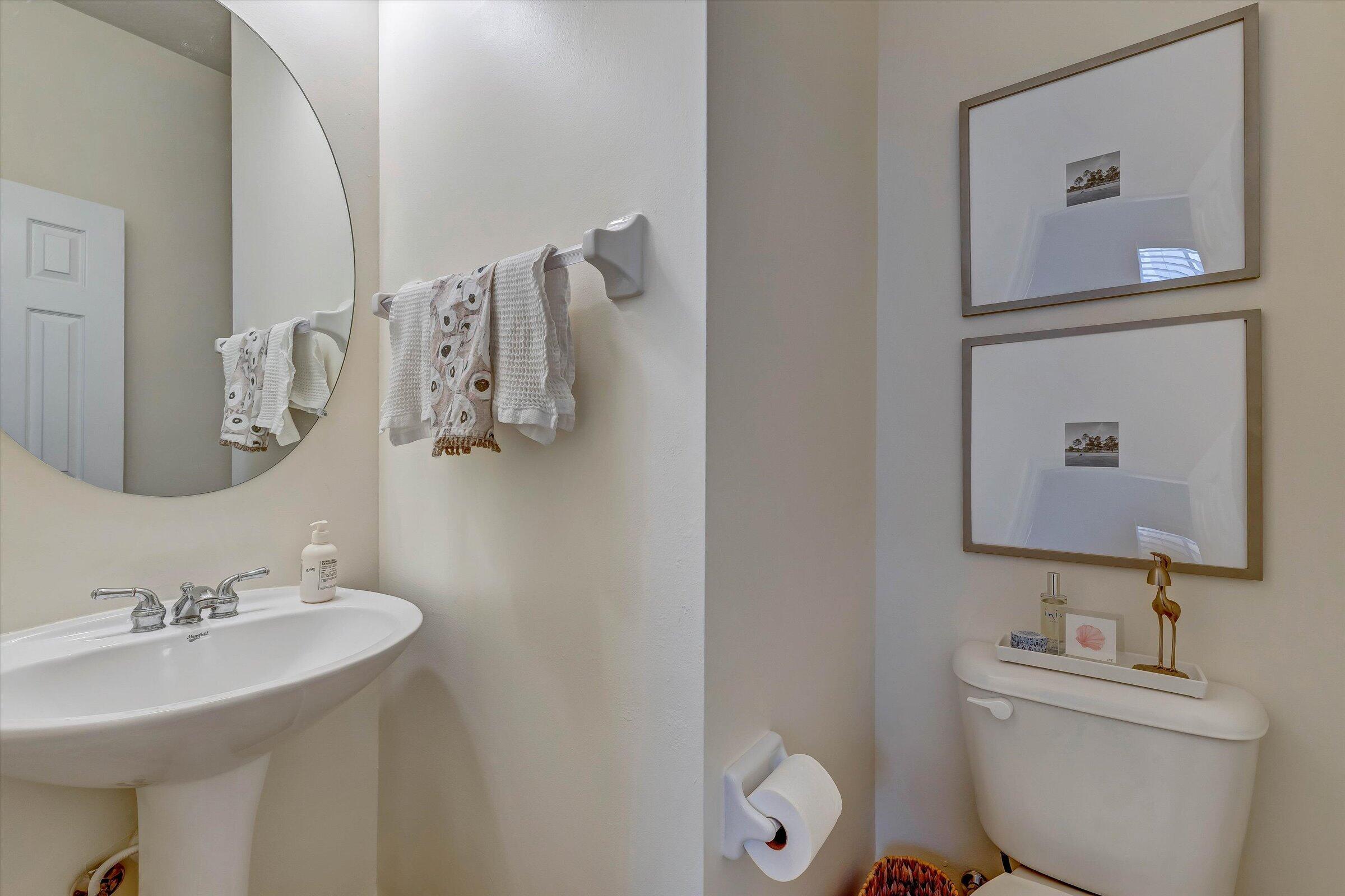 115 Pond Apple Lane, Unit 105 Jupiter, FL 33458 - Photo 35 of 38 a bathroom with a toilet sink and mirror
