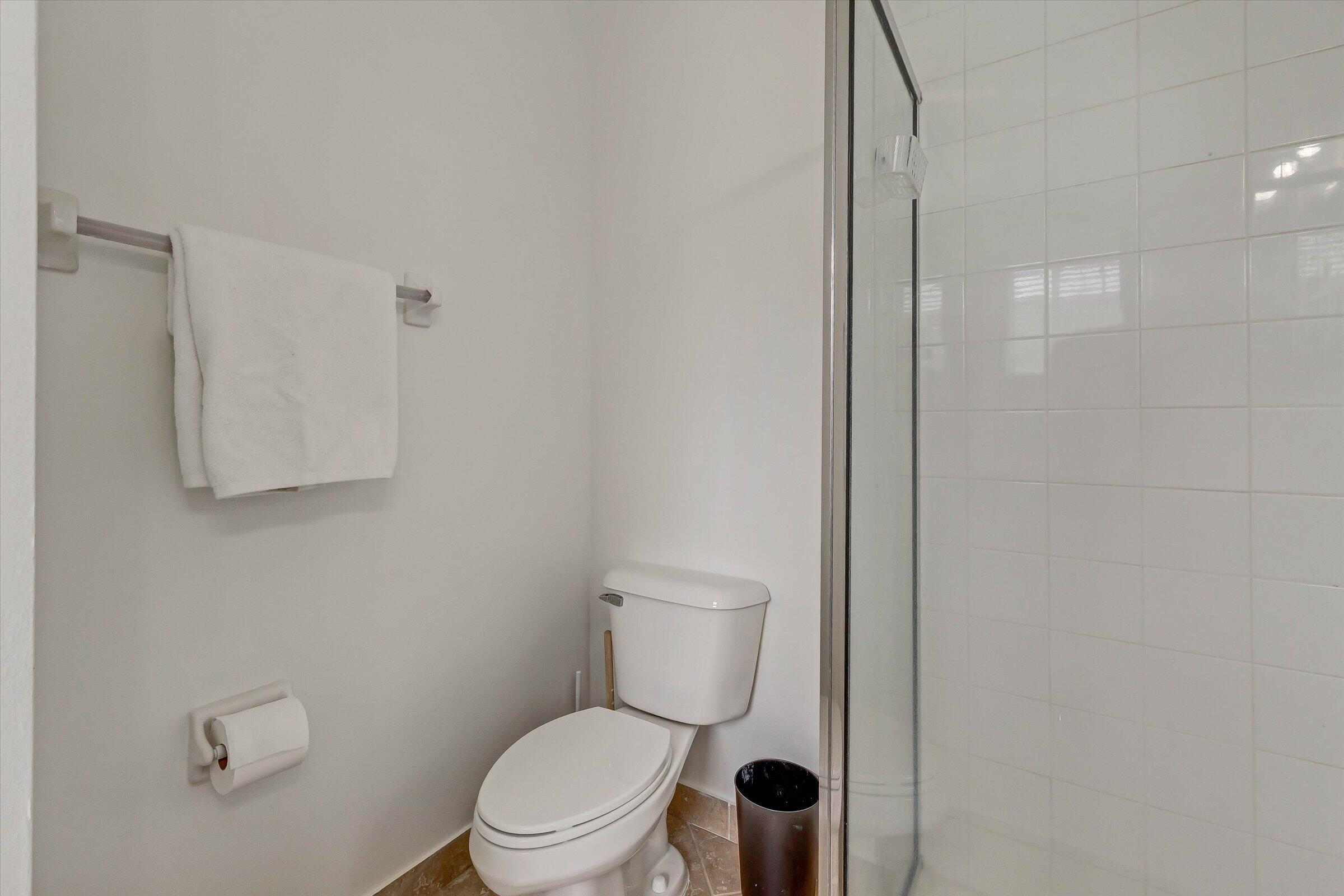 115 Pond Apple Lane, Unit 105 Jupiter, FL 33458 - Photo 36 of 38 a white toilet sitting next to a bathroom sink