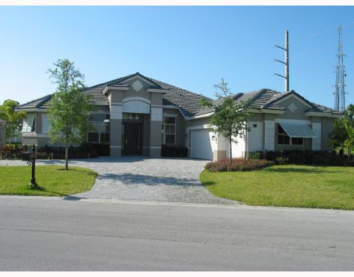 a front view of a house with a garden and plants