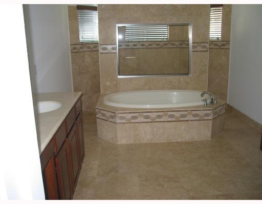 755 Southwest River Bend Circle Stuart, FL 34997 - Photo 7 of 8 a bathroom with a granite countertop sink a toilet and shower