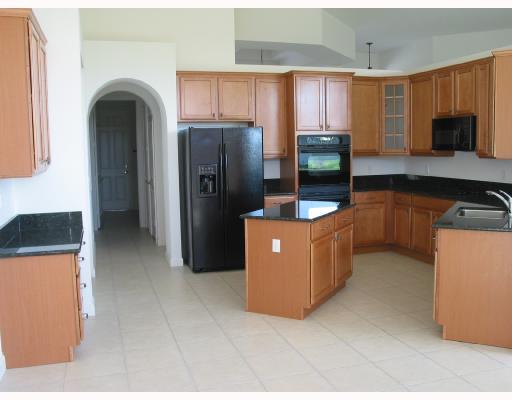 755 Southwest River Bend Circle Stuart, FL 34997 - Photo 8 of 8 a kitchen with stainless steel appliances granite countertop a refrigerator and a stove top oven