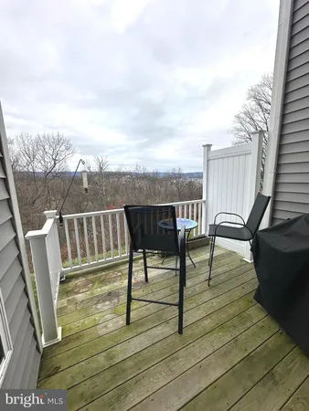 a view of deck with chairs and wooden floor