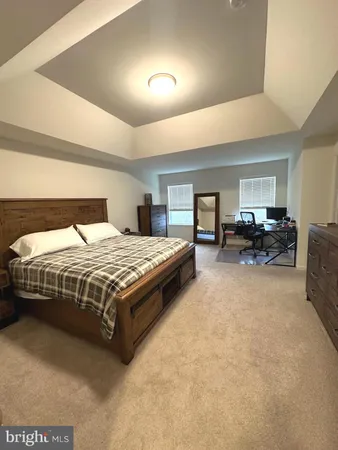 a bedroom with a large bed and a couch