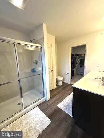 a spacious bathroom with a shower and a sink