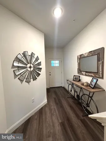 a view of a workspace with furniture and wooden floor