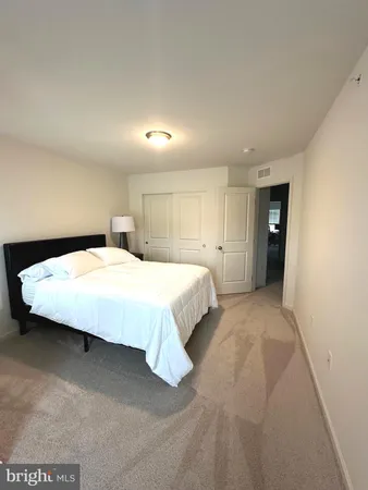 a bedroom with a large bed and closet