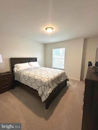 a large bed sitting in a bedroom next to a window