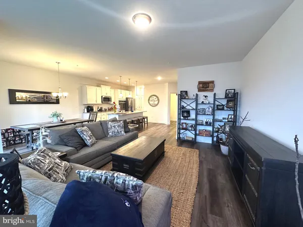a living room with furniture and a book shelf