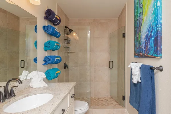 a bathroom with a sink toilet and shower