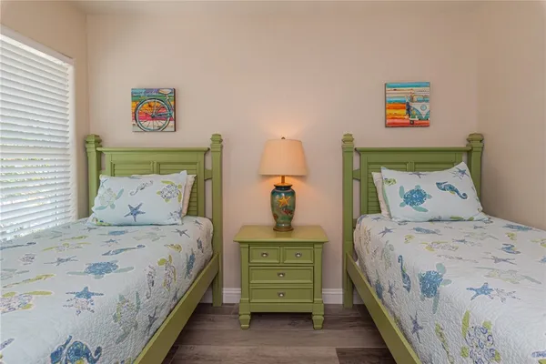 a bedroom with a bed and a painting on the wall