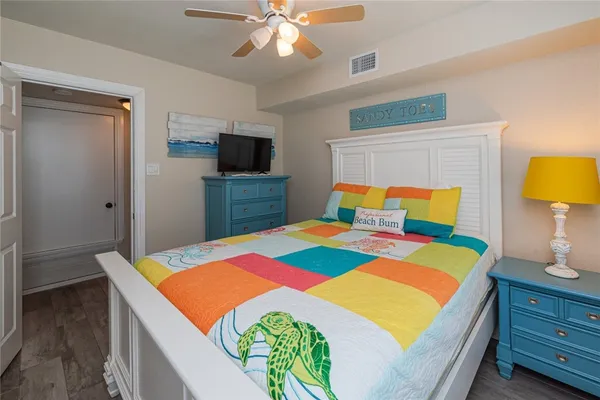 a bedroom with a bed and a flat screen tv