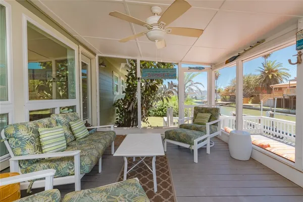a living room with furniture and a large window with garden view