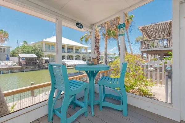 a dining room with furniture and a floor to ceiling window