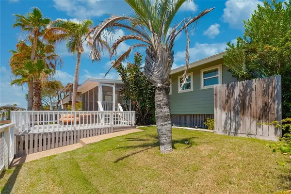 a view of a house with pool and chairs