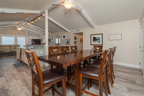 a view of a dining room with furniture and a chandelier