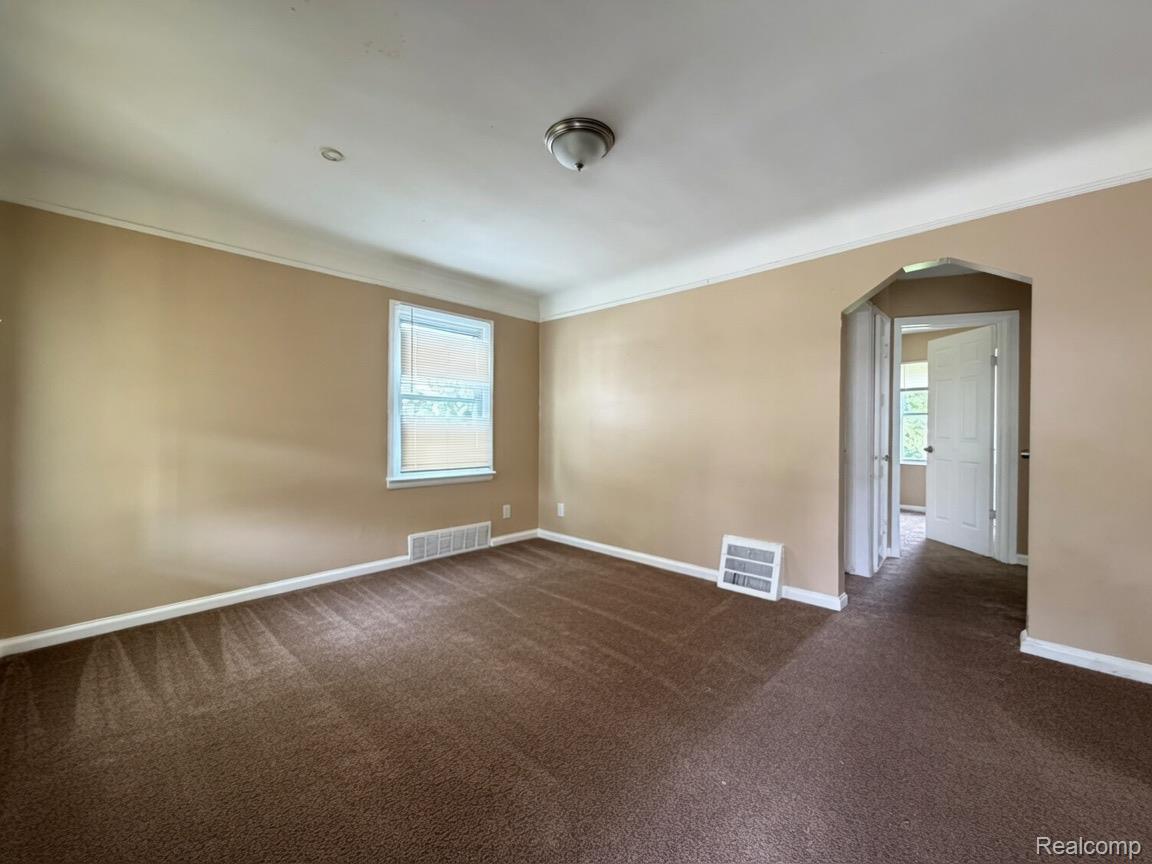 7286 Faust Avenue Detroit, MI 48228 - Photo 16 of 19 Interior room featuring brown carpeting, light tan painted walls, and white crown molding