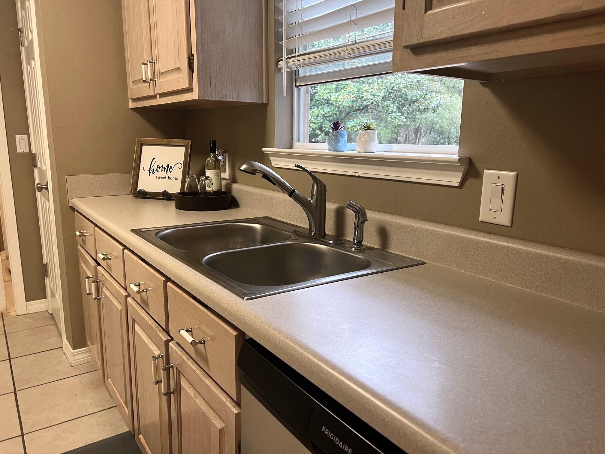 1860 Eagle Lane Navarre, FL 32566 - Photo 13 of 34 a kitchen with granite countertop a sink and cabinets
