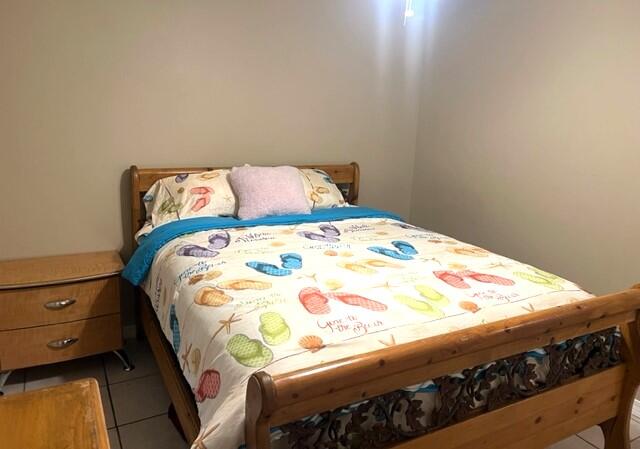 1860 Eagle Lane Navarre, FL 32566 - Photo 20 of 34 a bed sitting in a bedroom next to a cabinet