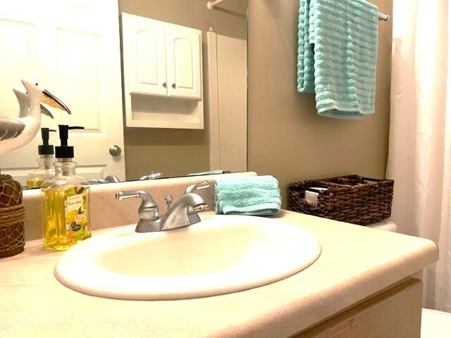 1860 Eagle Lane Navarre, FL 32566 - Photo 23 of 34 a bathroom with a sink and a mirror