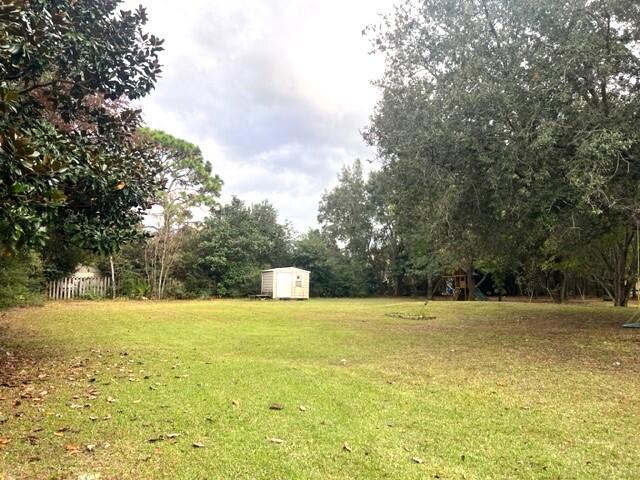 1860 Eagle Lane Navarre, FL 32566 - Photo 26 of 34 a view of yard with swimming pool and trees
