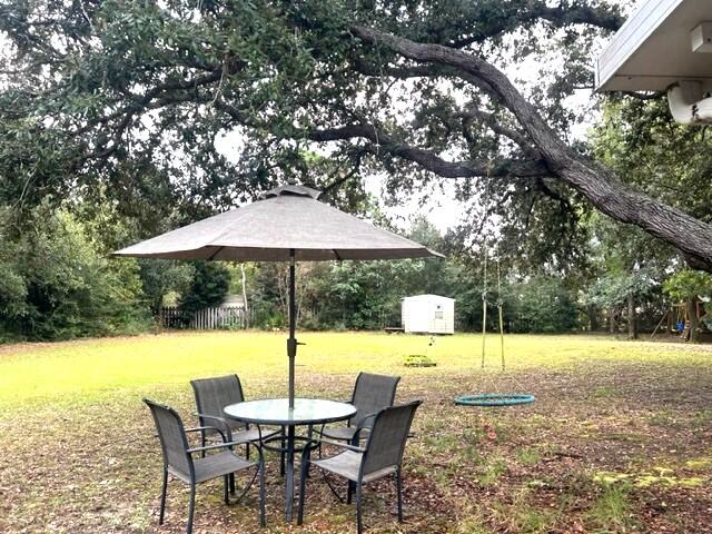 1860 Eagle Lane Navarre, FL 32566 - Photo 27 of 34 a backyard of a house with table and chairs