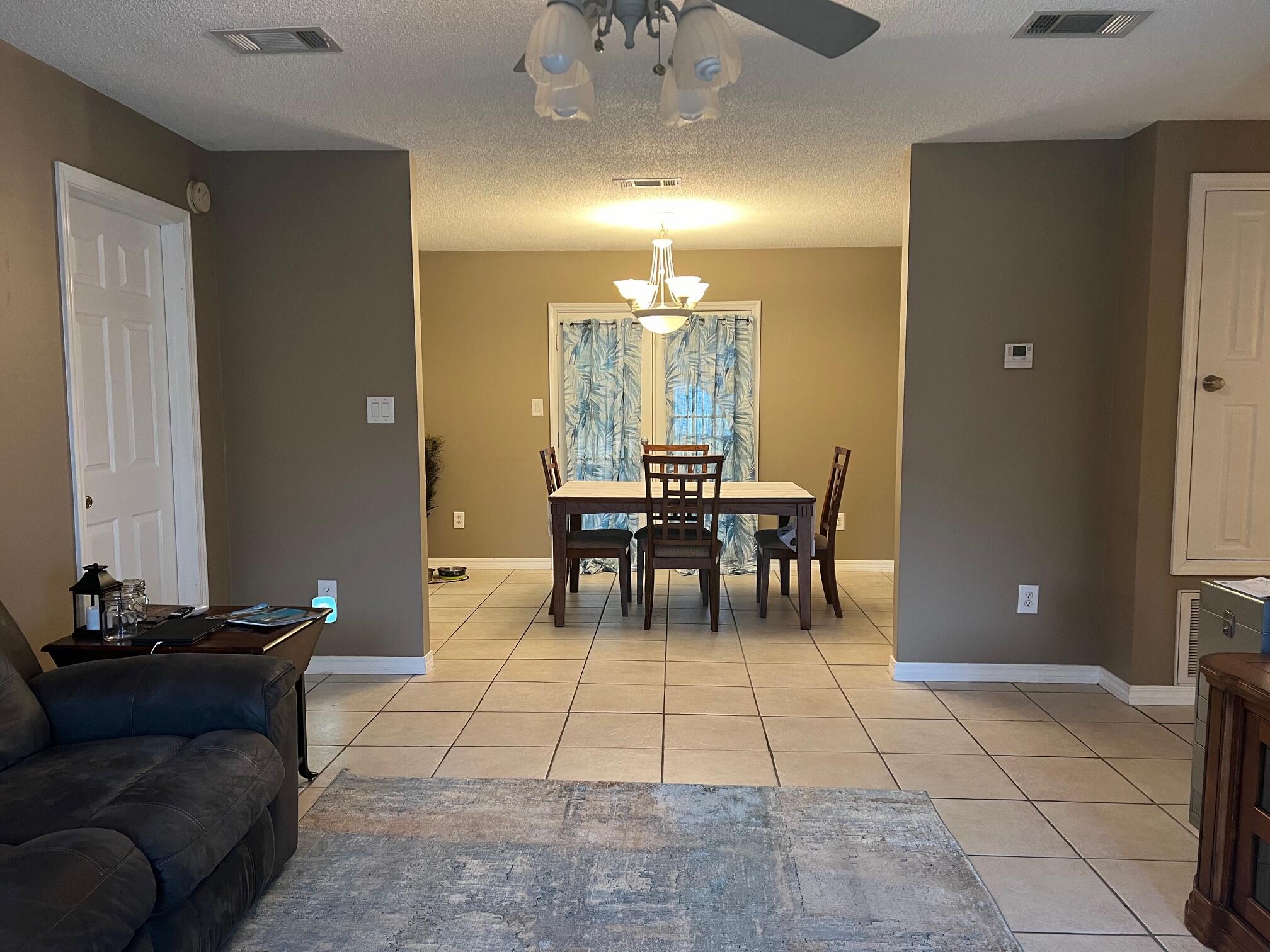 1860 Eagle Lane Navarre, FL 32566 - Photo 6 of 34 a living room with furniture and a chandelier