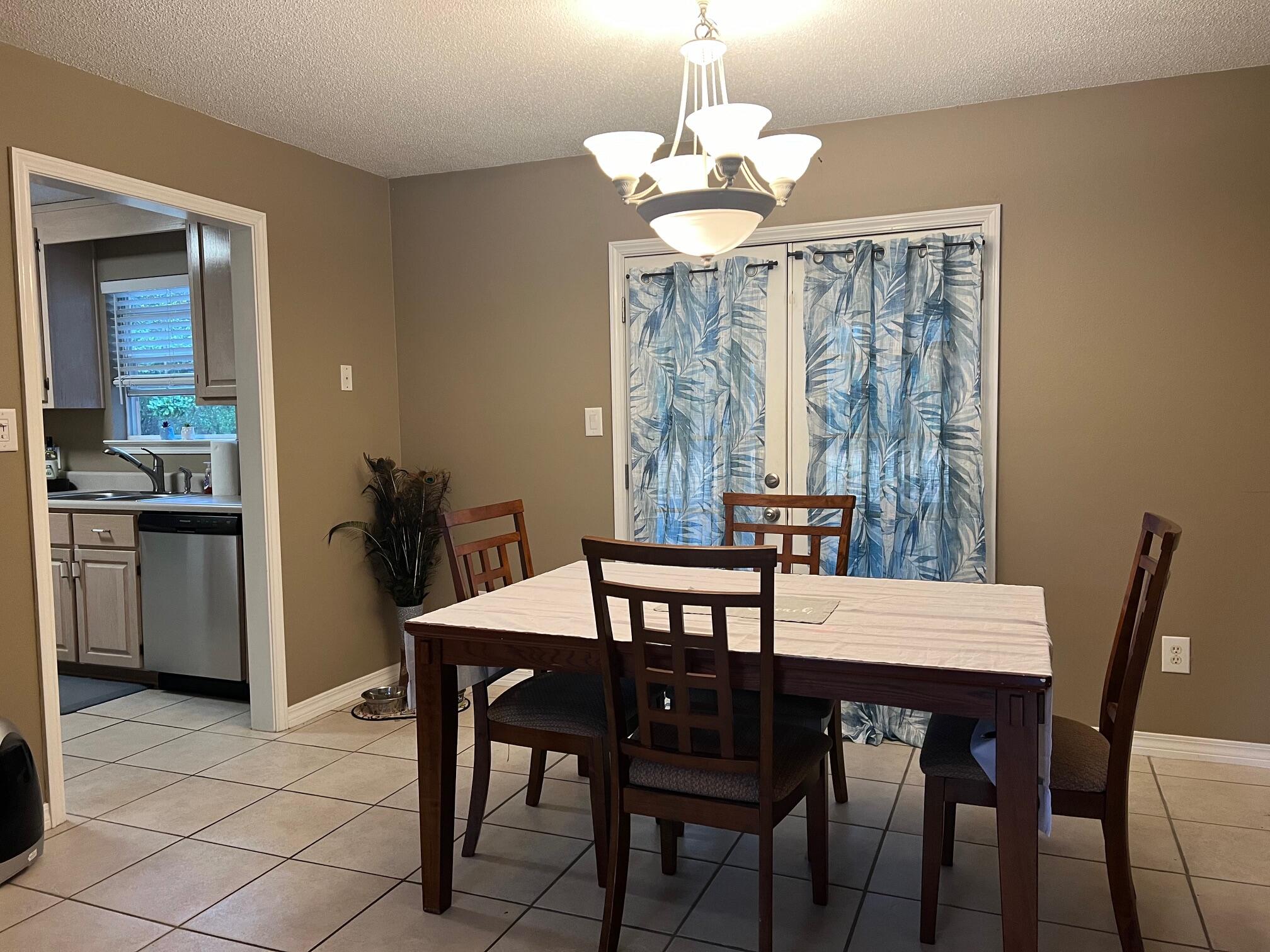 1860 Eagle Lane Navarre, FL 32566 - Photo 7 of 34 a view of a dining room with furniture window and wooden floor