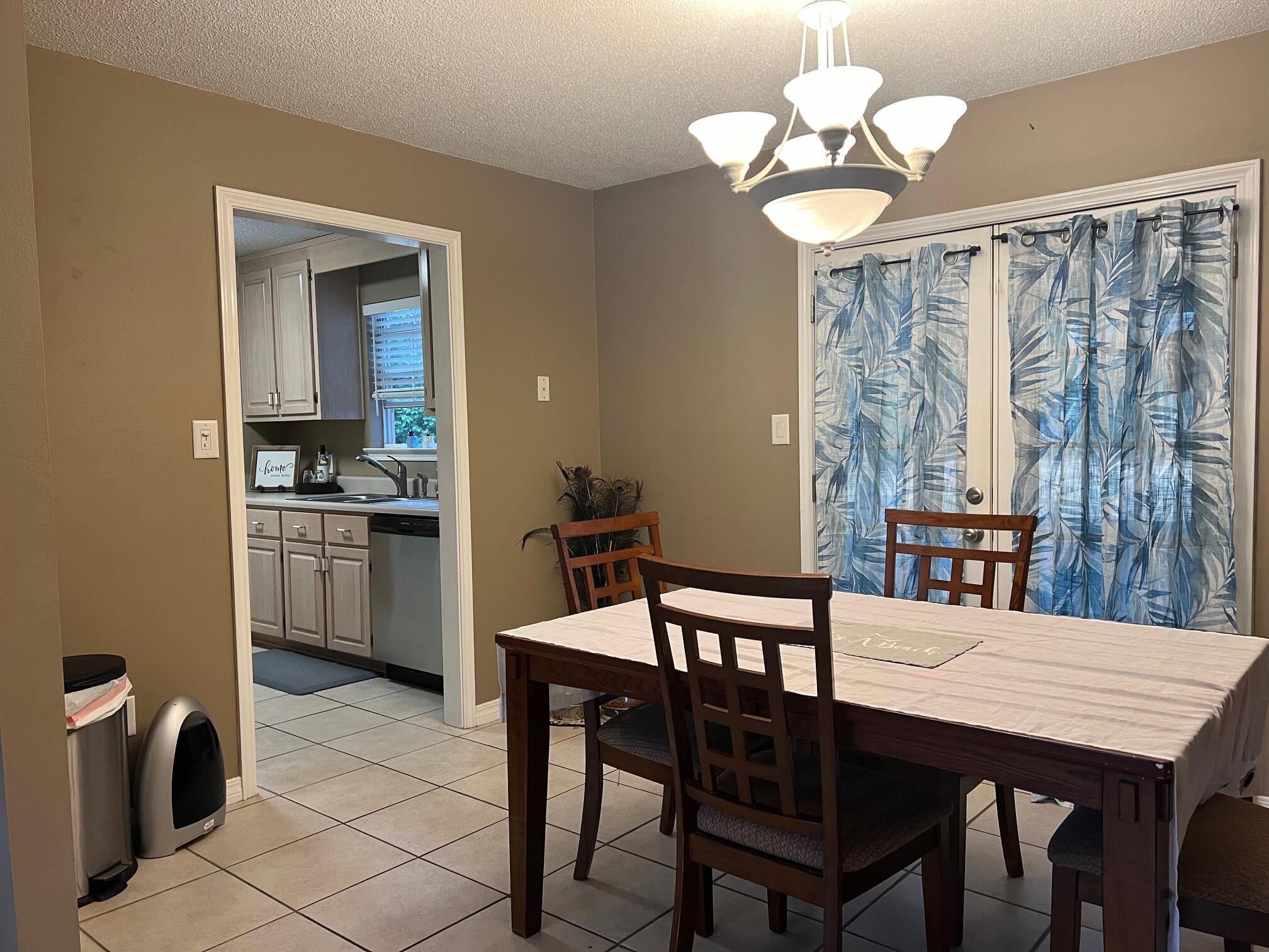 1860 Eagle Lane Navarre, FL 32566 - Photo 8 of 34 a view of a dining room with furniture and a chandelier
